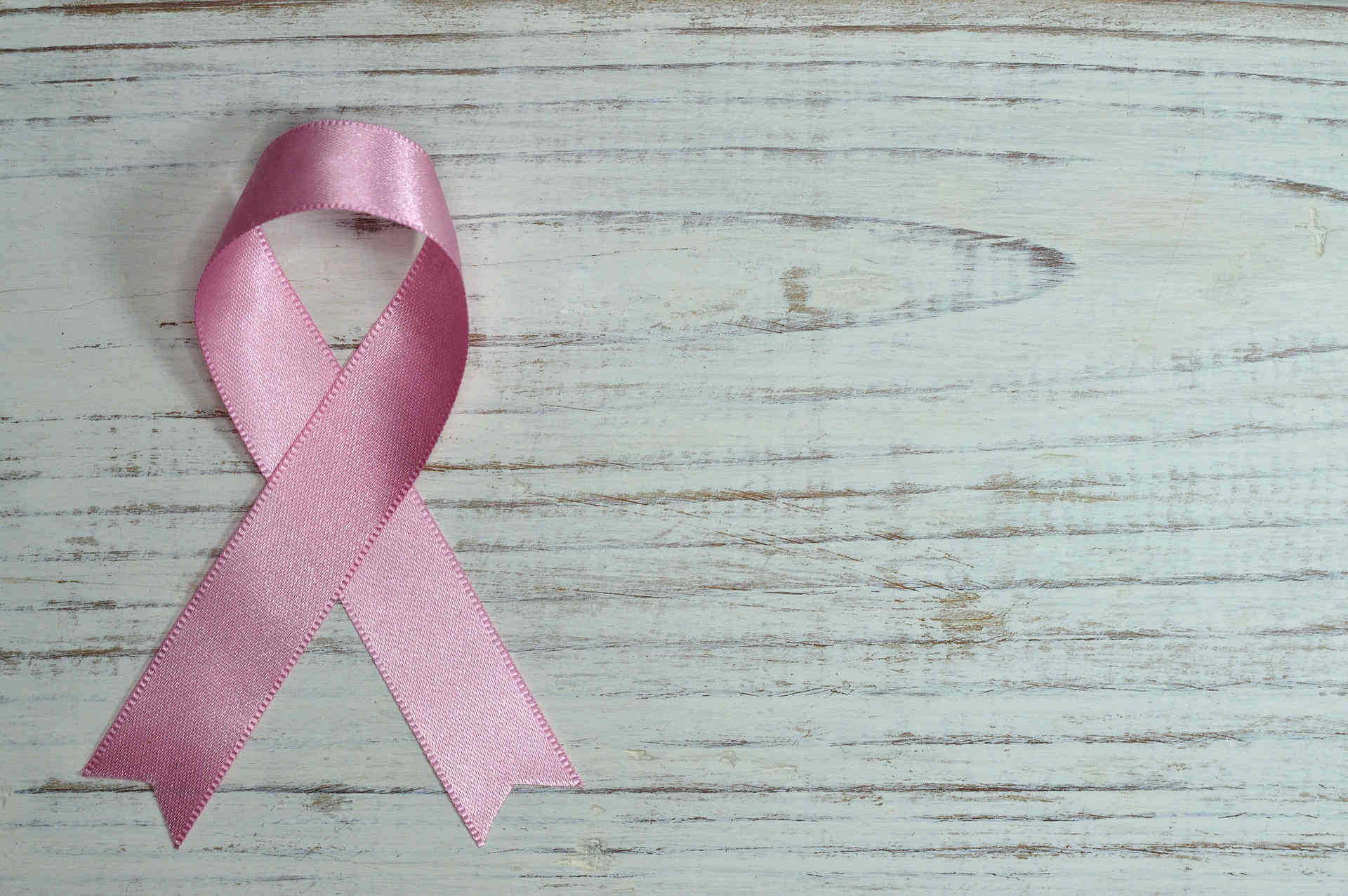 pink ribbon on wooden table - from pixabay